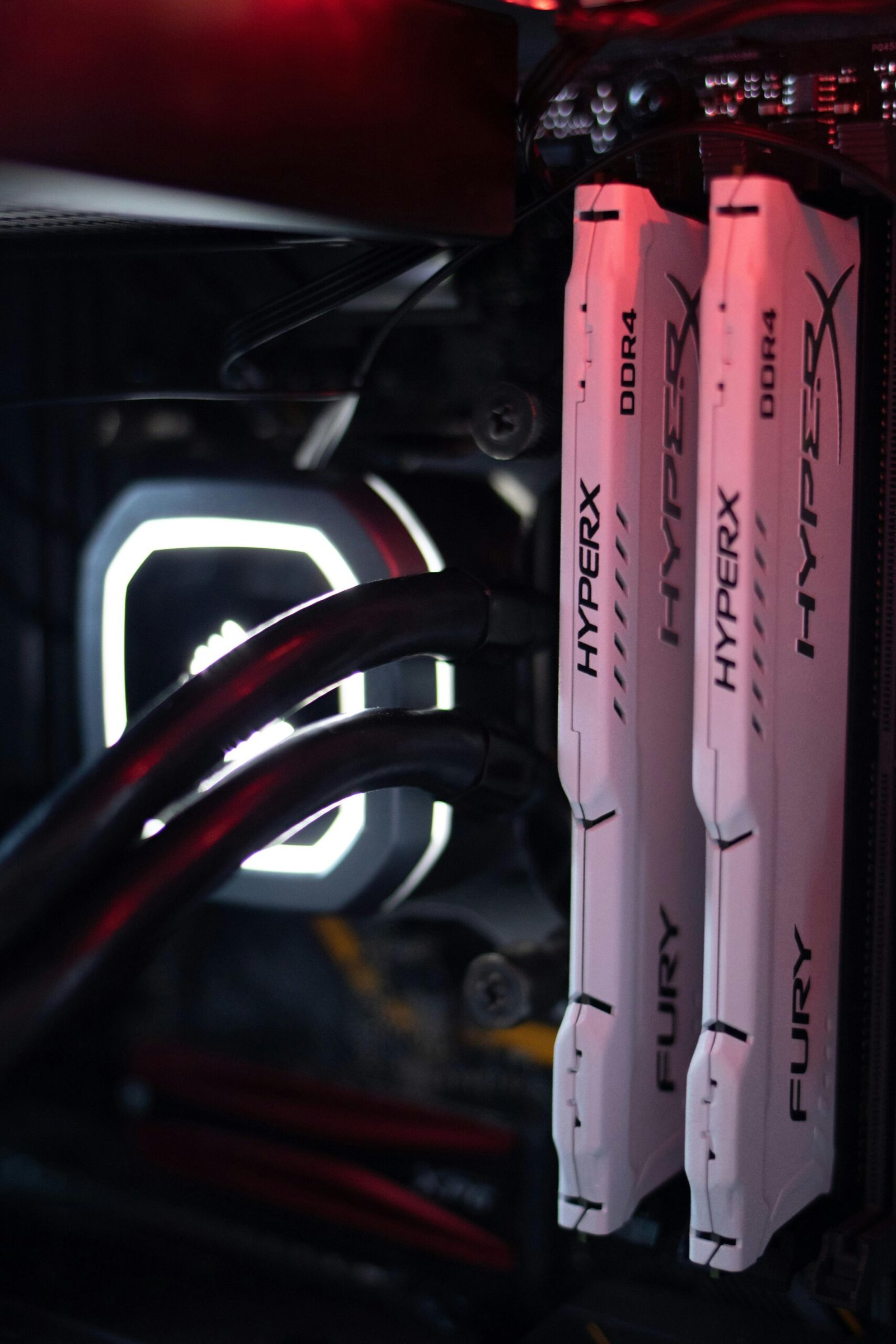 about-us Detailed view of HyperX Fury DDR4 RAM in a gaming PC build with LED lighting.
